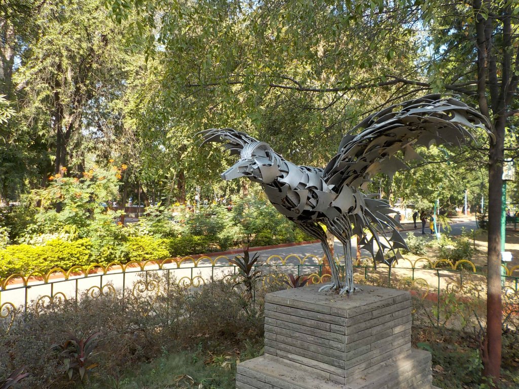 A sculpture of a bird in the park